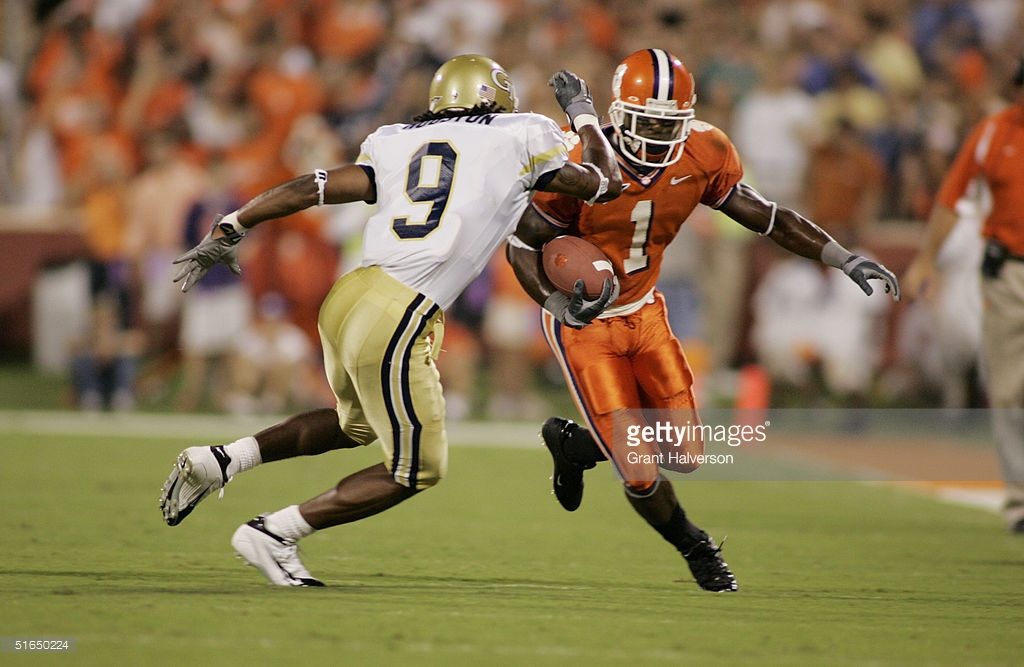 CLEMSON, SC - SEPTEMBER 11: Clemson University Tiger Airese Currie #1 runs upfiled and is met by Reuben Houston #9 of the Georgia Tech Yellow Jackets during an Atlantic Coast Conference game on September 11, 2004, at Clemson Memorial Stadium in Clemson, South Carolina. Georgia Tech defeated Clemson 28-24. (Photo By Grant Halverson/Getty Images) *** Local Caption *** Reuben Houston; Airese Currie