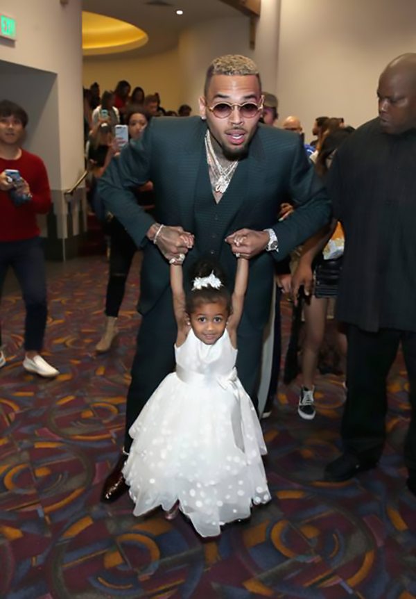 Chris Brown and daughter Royalty dance their way out of the theatre at the Premiere of Riveting Entertainment's "Chris Brown: Welcome To My Life" at L.A. LIVE (Photo by Jonathan Leibson | Getty Images for Riveting Entertainment)