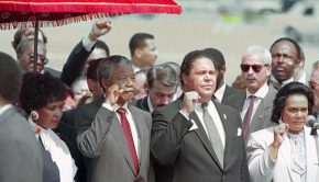 (Original Caption) Atlanta. Mayor Maynard Jackson (C) and Coretta Scott king, widow of slain civil rights leader Dr. Martin Luther King, Jr., join Nelson Mandela in holding up clenched fists during the playing of the Anthem of Mandela's African National Congress upon Mandela's arrival.