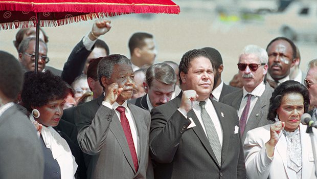 (Original Caption) Atlanta. Mayor Maynard Jackson (C) and Coretta Scott king, widow of slain civil rights leader Dr. Martin Luther King, Jr., join Nelson Mandela in holding up clenched fists during the playing of the Anthem of Mandela's African National Congress upon Mandela's arrival.