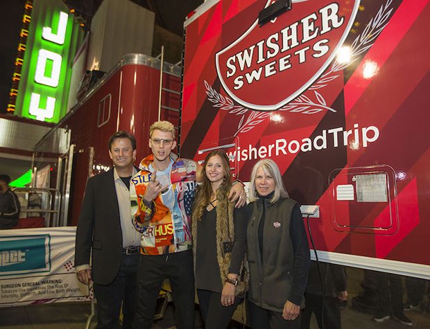 L to R: John Miller, President of Swisher International, Inc., Machine Gun Kelly, Michelle Burgstiner, Director of Consumer Engagement for Swisher Sweets and the Artist Project and Cherie Lee, VP of Creative and Consumer Engagement for Swisher International, Inc. (Photo: Marc Morrison)