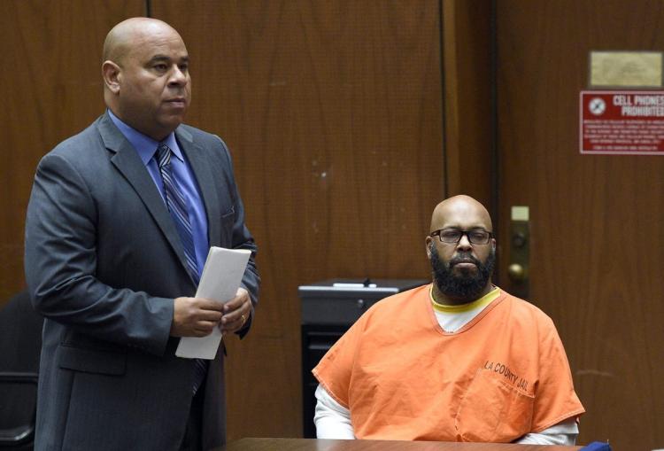 n this March 20, 2015 photo, Attorney Matthew Fletcher, left, speaks for his client, Marion "Suge" Knight, right, in a court appearance for a bail review hearing in his murder case in Los Angeles. (AP Photo/Robyn Beck, Pool, File)