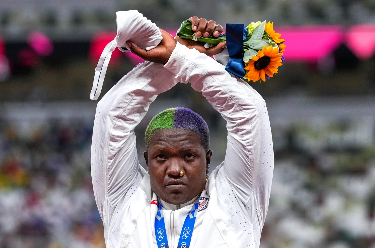 U.S. shot putter Raven Saunders protests on the podium with her silver medal after competing the women’s shot put. Ina Fassbender/AFP via Getty Images