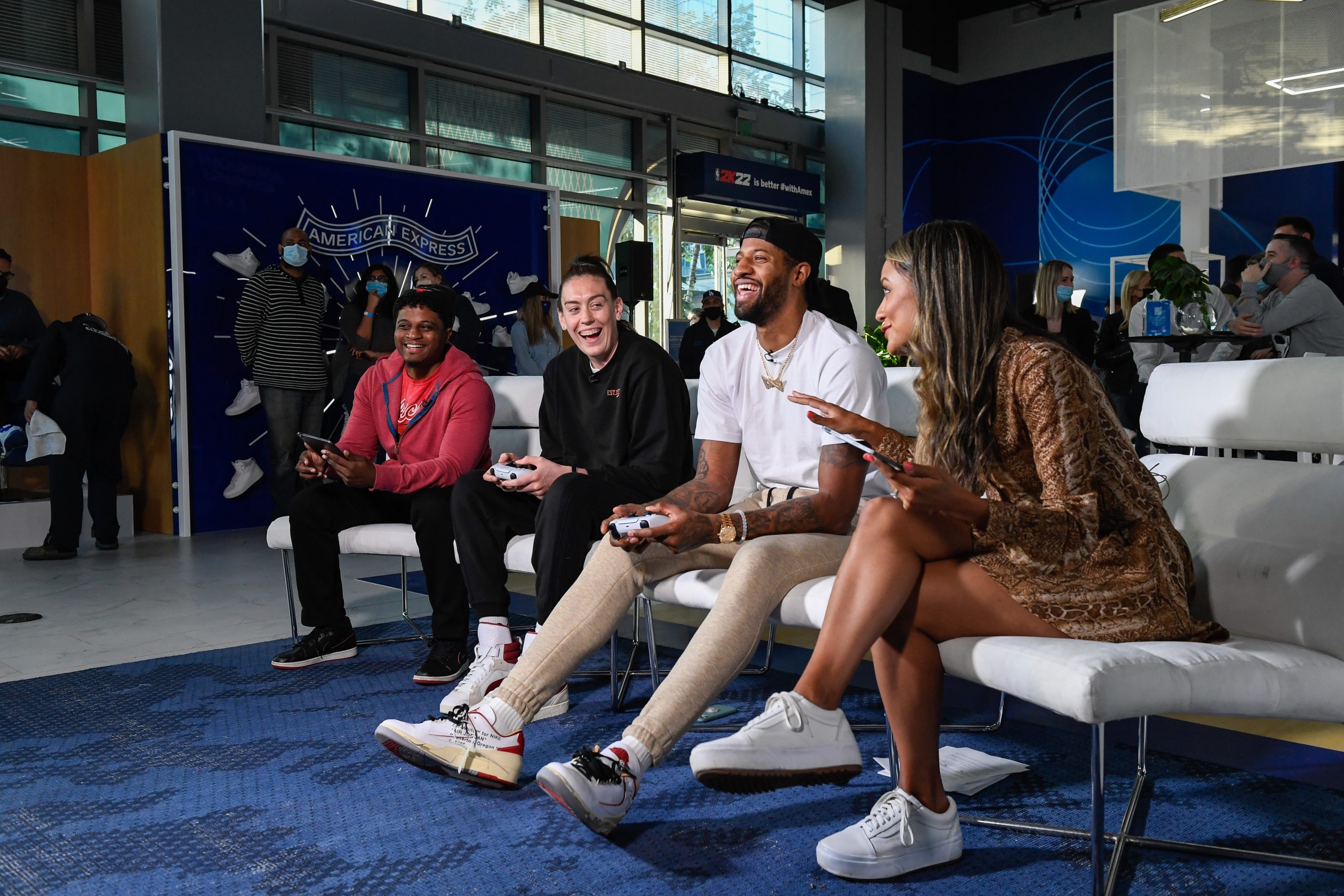 NBA star Paul George, second form right, and WNBA star Breanna Stewart, second from left, face-off in a live NBA 2K22 game at the American Express x NBA 2K22 experience on Friday, Dec. 10, 2021, in Los Angeles. (Kyusung Gong/American Express via AP Images)
