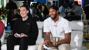 NBA star Paul George, right, and WNBA star Breanna Stewart face-off in a live NBA 2K22 game at the American Express x NBA 2K22 experience on Friday, Dec. 10, 2021, in Los Angeles. (Kyusung Gong/American Express via AP Images)