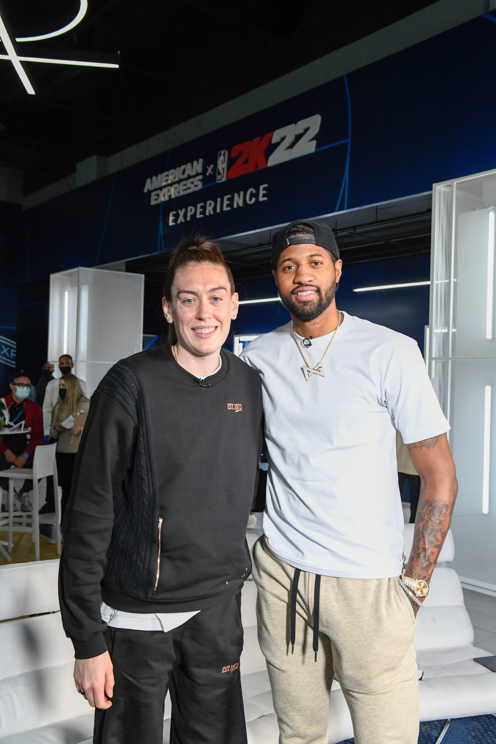 NBA star Paul George, right, and WNBA star Breanna Stewart pose at the American Express x NBA 2K22 experience on Friday, Dec. 10, 2021, in Los Angeles. (Kyusung Gong/American Express via AP Images)