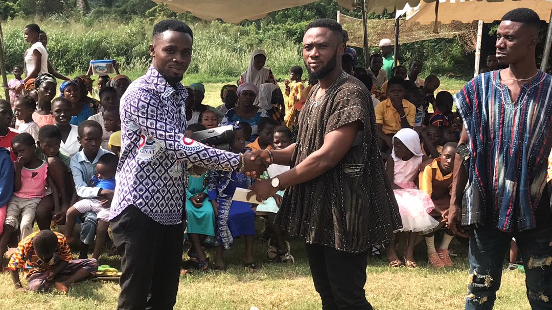Oheneba (Prince) Opoku Branor Eric, greets the Headmaster of Pataban M/A Basic School in Ghana