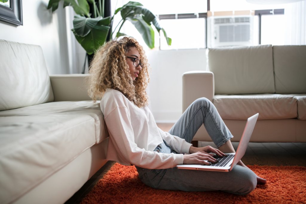 woman sitting on floor and leaning on couch using laptop - thought-catalog-Nv-vx3kUR2A-unsplash