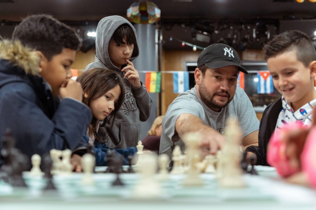 Russell Makofsky founder of The Gift of Chess with young chess students - small (Photo: The Gift of Chess)