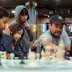 Russell Makofsky founder of The Gift of Chess with young chess students - small (Photo: The Gift of Chess)