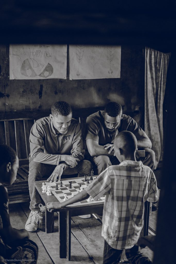 The Gift of Chess - an instructor with students play a game of chess