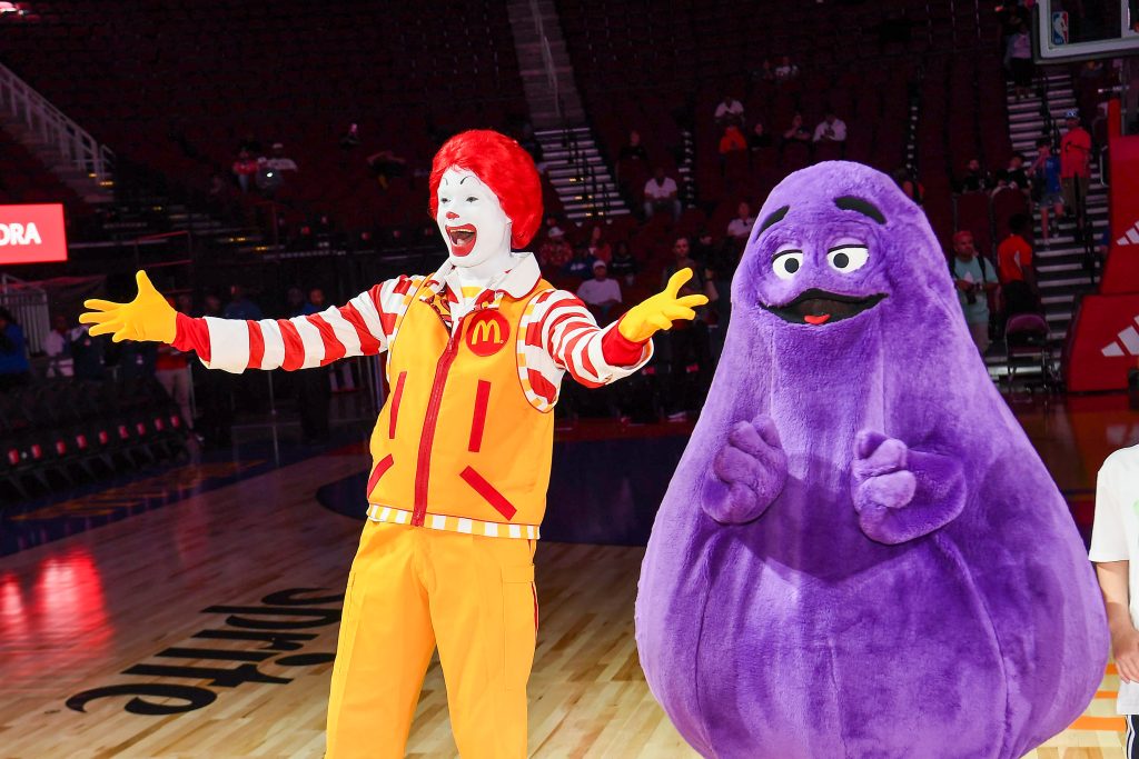 HOUSTON, TEXAS - APRIL 02: Perfromers in "Ronald McDonald" and "Grimace" costumes attend the 47th annual McDonald's All American Games at Toyota Center on April 02, 2024 in Houston, Texas. (Photo by Marcus Ingram/Getty Images for the McDonalds All American Games)